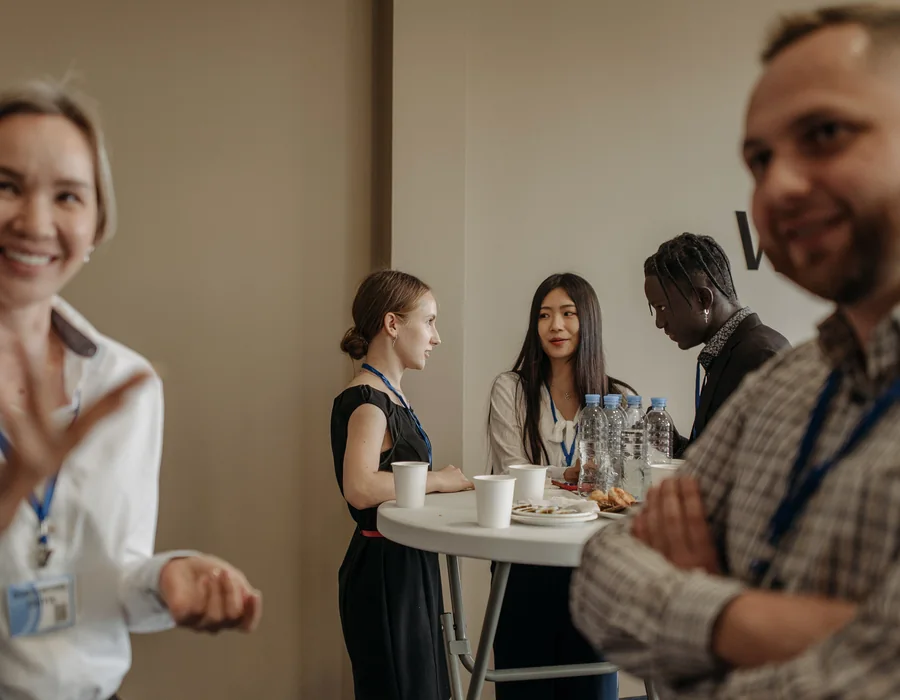Professionals talking during a business event networking break
