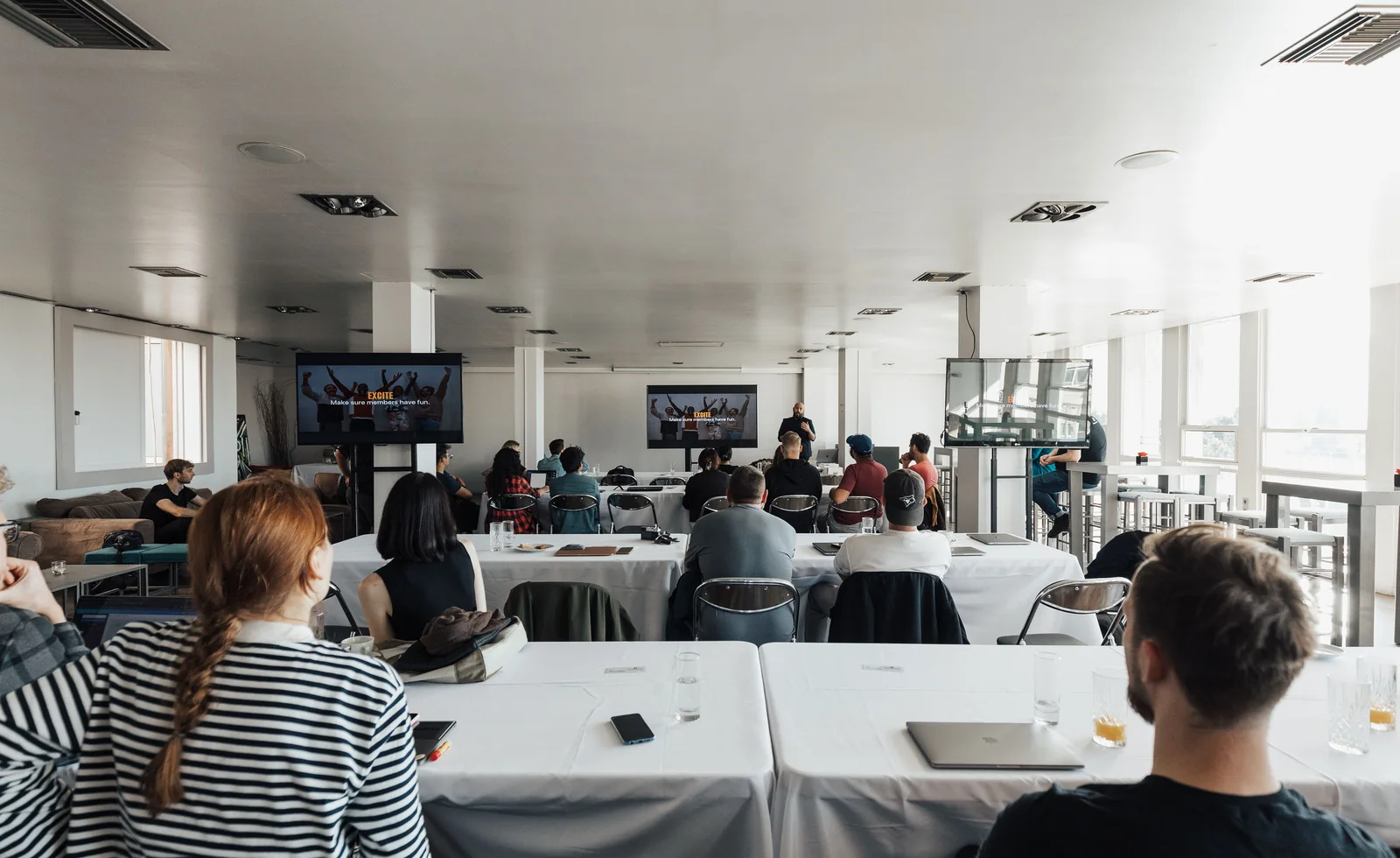 Professionals attending a presentation in a bright meeting venue